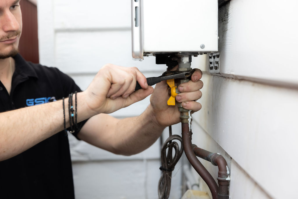 GSK Plumbing Solutions plumber installing a hot water system in Sydney